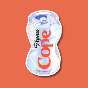 May include: A crushed silver aluminum soda can sticker with a white border. The text Tryna Cope is printed in black and orange, and the text Holding Space Co is printed in small blue letters at the bottom of the can. The can has a metallic finish.