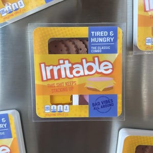 May include: Several packages of novelty food items with the word "Irritable" in large letters. The packages have a yellow and orange design with the text "Tired & Hungry" and "Bad Vibes All Around."