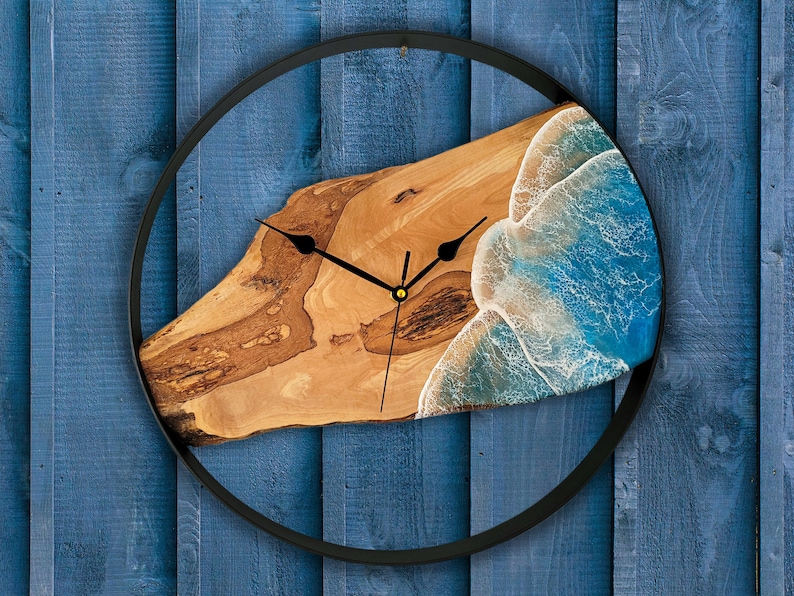 Olive wood and metal  wall clock
Close-up of resin ocean art on clock
Timeless Tides clock on a rustic wall
Customizable modern olive wood clock
Unique wall clock perfect for gifts