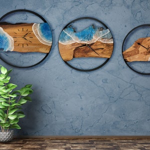 Olive wood and metal  wall clock
Close-up of resin ocean art on clock
Timeless Tides clock on a rustic wall
Customizable modern olive wood clock
Unique wall clock perfect for gifts