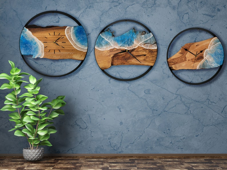 Olive wood and metal  wall clock
Close-up of resin ocean art on clock
Timeless Tides clock on a rustic wall
Customizable modern olive wood clock
Unique wall clock perfect for gifts
