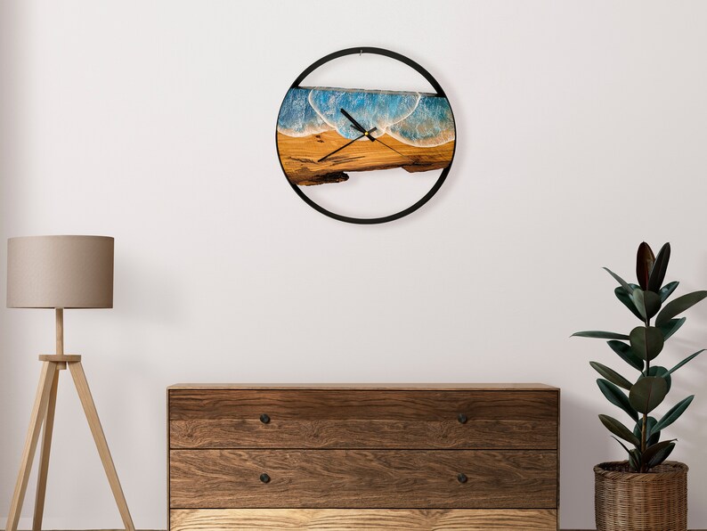 Olive wood and metal  wall clock
Close-up of resin ocean art on clock
Timeless Tides clock on a rustic wall
Customizable modern olive wood clock
Unique wall clock perfect for gifts