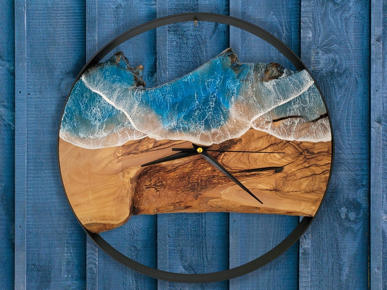 Olive wood and metal  wall clock
Close-up of resin ocean art on clock
Timeless Tides clock on a rustic wall
Customizable modern olive wood clock
Unique wall clock perfect for gifts