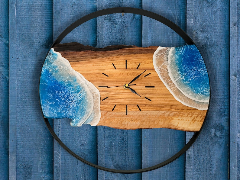 Olive wood and metal  wall clock
Close-up of resin ocean art on clock
Timeless Tides clock on a rustic wall
Customizable modern olive wood clock
Unique wall clock perfect for gifts