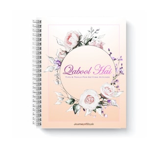 May include: A spiral bound notebook with a peach background and a floral wreath design. The wreath is made of white and pink roses, purple flowers, and green leaves. The text "Qabool Hai" is written in pink script inside the wreath. The text "Tips & Tools for Getting Hitched" is written in black below the wreath. The text "Journeyof2byak" is written in black at the bottom of the page.