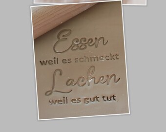 May include: Purple 3D printed stamp with the text "Essen weil es schmeckt Lachen weil es gut tut" in a cursive font.
