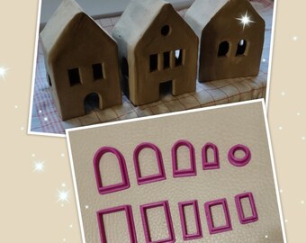Puede incluir: Conjunto de cortadores de galletas de plástico rosa en forma de ventanas y arcos. Los cortadores están dispuestos en dos filas sobre una superficie marrón.