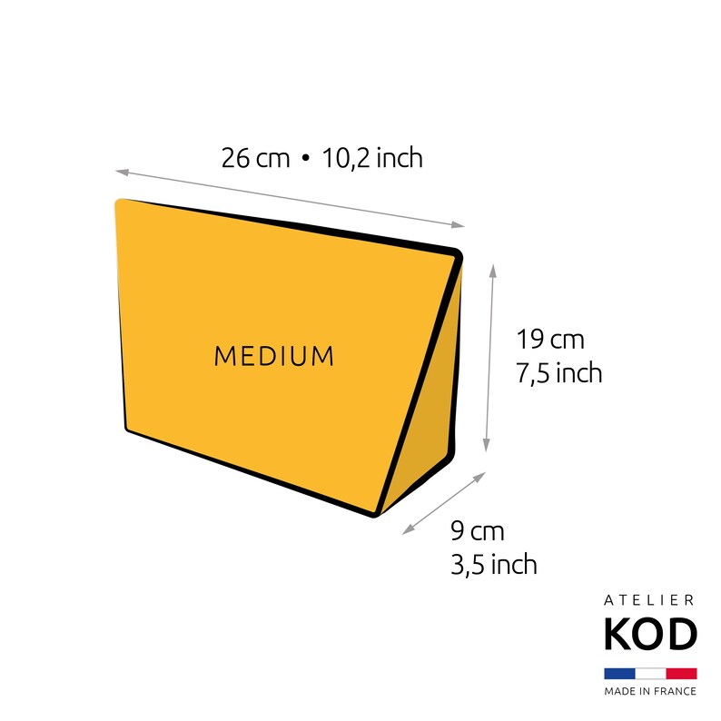 May include: A yellow triangular wedge pillow labeled "MEDIUM" with measurements in inches and centimeters. The pillow is 26 inches (66 cm) wide, 7.5 inches (19 cm) tall, and 3.5 inches (9 cm) deep.