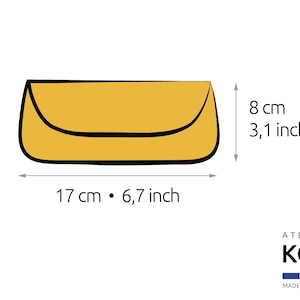 May include: A yellow envelope-style clutch bag with a curved flap and black outline. The dimensions are 17 cm by 8 cm, which is 6.7 inches by 3.1 inches. The image includes the text ATELIER KOD and MADE IN FRANCE with a French flag icon.