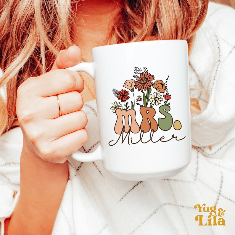 May include: White ceramic mug with a floral design and the text "MRS. Miller" in a retro font.