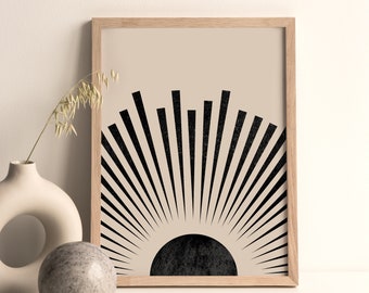 May include: A framed print with a minimalist design featuring a black sunburst on a beige background.