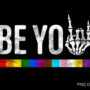 May include: White text on a black background reads "BE YOU" with a white skeleton hand making a rock and roll sign. A rainbow stripe is below the text.
