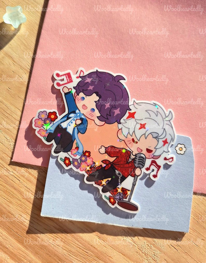 May include: Two cartoon stickers featuring anime-style characters. One character has purple hair and is wearing a blue outfit, while the other has white hair and a red jacket, holding a microphone. Both are surrounded by musical notes and flowers.
