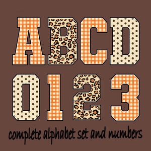 May include: A digital graphic featuring the letters A, B, C, D and numbers 0, 1, 2, 3 in a varsity font style. The characters display orange gingham, leopard print, and brown polka dot patterns on a solid brown background with the text complete alphabet set and numbers.