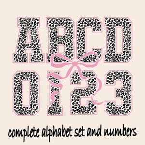 May include: A design featuring the letters ABCD and numbers 0123, with a leopard print pattern and pink outlines. A pink bow is between the letters and numbers. The text "complete alphabet set and numbers" is at the bottom.