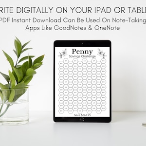 May include: A digital tablet displaying a printable penny savings challenge. The challenge is a honeycomb grid with numbers representing the amount to save each day. The text on the tablet reads "Penny Savings Challenge" and "Save $667.95".