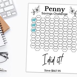May include: A black and white printable penny savings challenge chart with a hexagonal grid. The chart has a title that reads "Penny Savings Challenge". The chart has a total of 65 hexagons, each with a dollar amount printed inside. The chart has a section at the bottom that reads "I did it! Save $667.95".