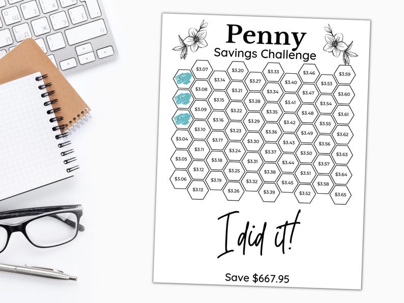 May include: A black and white printable penny savings challenge chart with a hexagonal grid. The chart has a title that reads "Penny Savings Challenge". The chart has a total of 65 hexagons, each with a dollar amount printed inside. The chart has a section at the bottom that reads "I did it! Save $667.95".