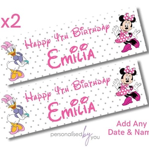 May include: Two printable favour tags featuring a cartoon image of Minnie Mouse and Daisy Duck. The tags are white with grey polka dots and pink text that reads "Happy 4th Birthday Emilia".