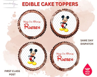 May include: Four edible cake toppers featuring Mickey Mouse. Two toppers have a white background with red polka dots and the text "Happy 2nd Birthday Rueben". The other two toppers have a white background with red polka dots and a cartoon image of Mickey Mouse.