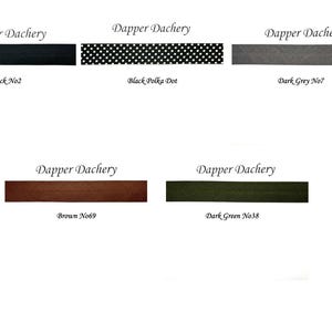May include: Five fabric swatches with the text "Dapper Dachery" above each swatch. The swatches are labeled "Black No2", "Black Polka Dot", "Dark Grey No7", "Brown No69", and "Dark Green No38".