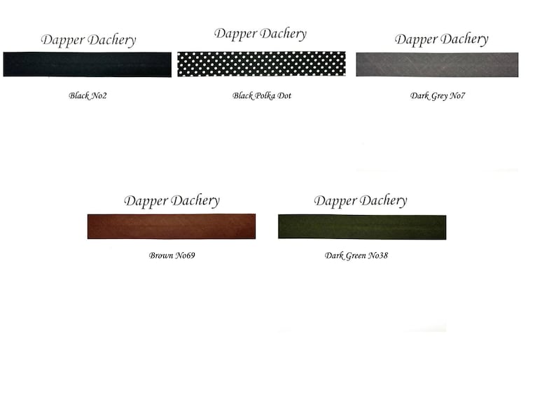 May include: Five fabric swatches with the text "Dapper Dachery" above each swatch. The swatches are black, black with white polka dots, dark gray, brown, and dark green.