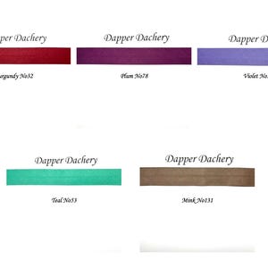 May include: Five fabric swatches in different colors, labeled with the brand name "Dapper Dachery" and color names and numbers: Burgundy No32, Plum No78, Violet No76, Teal No53, and Mink No131.
