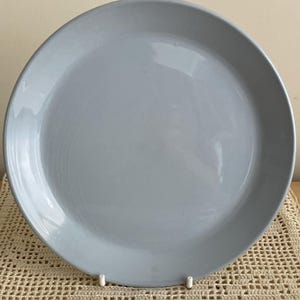 May include: A plain, light blue ceramic dinner plate.