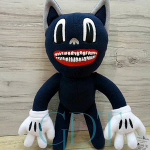 May include: A blue cartoon cat plush toy with a large toothy grin and white gloves. The toy is standing on a wood grain surface. The tag on the toy reads 'Hand Made 100% polyester'. 