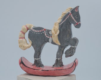 Ceramic rocking horse sculpture