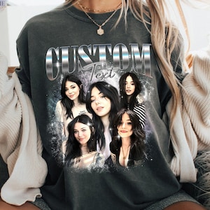 May include: Dark gray sweatshirt with a custom text design. The design features a collage of images of a person, with the word "CUSTOM" in a silver, metallic font above the word "Text". The sweatshirt is a comfortable, casual style.