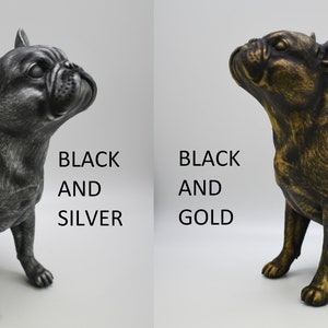 Pu&ograve; includere: Due figurine di Bulldog Francese, una in nero e argento, l'altra in nero e oro. BLACK AND SILVER e BLACK AND GOLD sono scritti sotto ogni figurina.