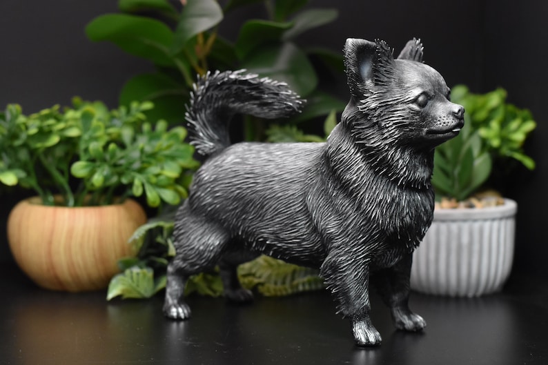 Puede incluir: Una figurita de cer&aacute;mica negra de un perro chihuahua. La figurita est&aacute; de pie sobre una superficie negra y tiene un aspecto realista.
