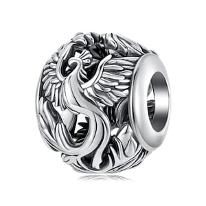 May include: Silver charm bead featuring a detailed, three-dimensional design of a phoenix with outstretched wings.