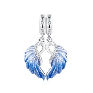 May include: A silver charm with two blue angel wings that are joined together in the shape of a heart. The wings are accented with clear cubic zirconia stones.