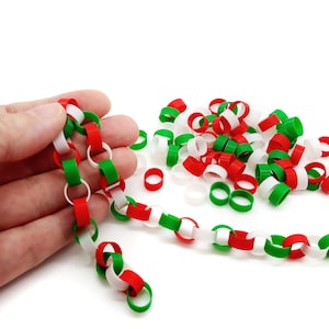 May include: A string of red, white and green plastic chain links. The chain is made of individual rings that are linked together. The chain is a popular Christmas decoration.