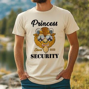 Op de afbeelding: Een beige T-shirt met een cartoon afbeelding van een beest dat een zonnebril draagt. De tekst "Princess" staat boven de afbeelding en "Since 2025 Security" eronder.