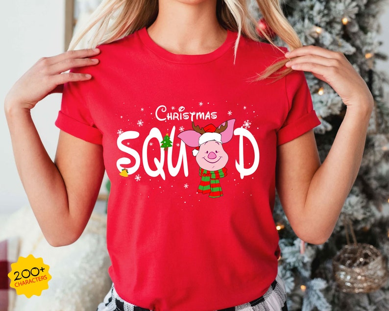 May include: Red t-shirt with a white graphic of a pig wearing a Santa hat and the text "The Christmas Squad".