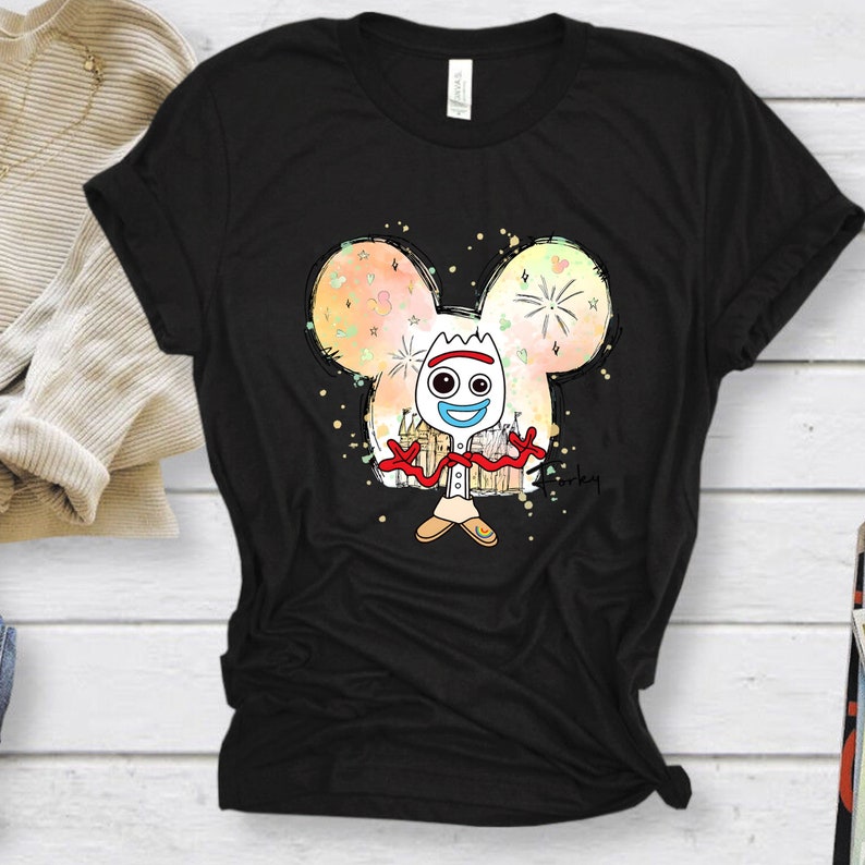 May include: Black t-shirt with a white cartoon character of Forky from Toy Story. Forky is standing in front of a colorful Mickey Mouse head with fireworks and stars. The text "Forky" is written in the bottom right corner.