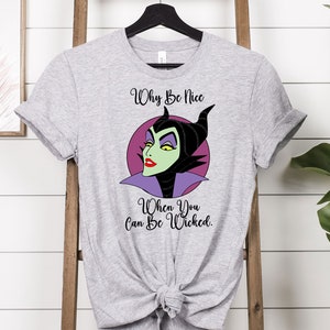 May include: Gray t-shirt with a cartoon image of Maleficent from Disney's Sleeping Beauty. The text "Why Be Nice When You Can Be Wicked." is printed on the shirt.