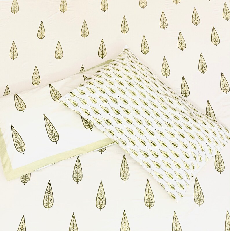 May include: Two white pillowcases with a green leaf pattern. The pillowcases are made of cotton and have a soft, comfortable feel.