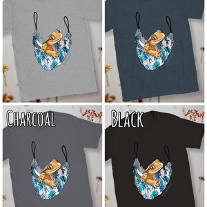 May include: Four t-shirts in different colors: sports grey, dark heather, charcoal, and black. Each shirt features a cartoon illustration of a crested gecko in a hammock with a floral pattern.
