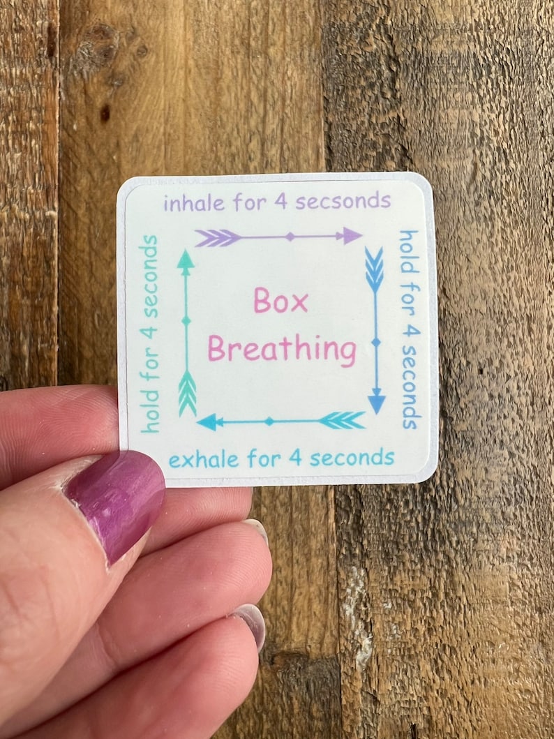 May include: A white sticker with a blue, pink, and green box breathing diagram. The diagram shows arrows with the text "inhale for 4 seconds", "hold for 4 seconds", "exhale for 4 seconds", and "hold for 4 seconds". The text "Box Breathing" is in the center of the box.