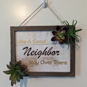 Like a good neighbor stay over there door sign