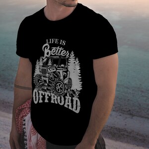 May include: A black t-shirt with a white graphic design featuring an off-road vehicle and the text "Life is Better Offroad".