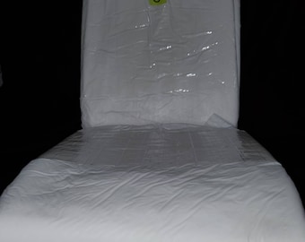 May include: A white adult diaper with a label that says "S" on it. The diaper is folded and wrapped in plastic.