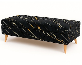 May include: A rectangular ottoman with a black velvet fabric featuring gold veining. The ottoman has four wooden legs and a hinged top for storage. The design is reminiscent of marble.