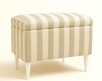 May include: A rectangular storage ottoman with a striped pattern in beige and light gray. The ottoman has a hinged lid and is supported by four white, tapered legs. The design is simple and elegant.