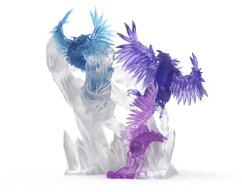 May include: Three crystal phoenix figurines, one blue, one purple and one pink, perched on a clear crystal base.