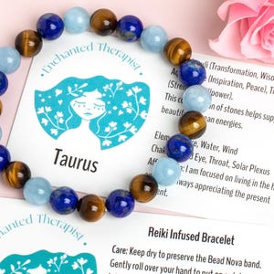 May include: A blue and brown beaded bracelet with a card that says "Enchanted Therapist" and "Taurus". The card also includes information about the stones used in the bracelet and their meanings.